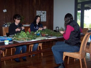 three women propogating plant cuttings